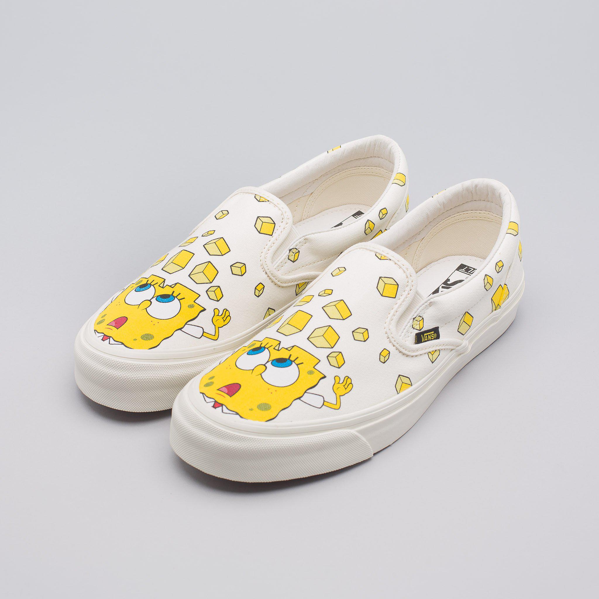 white and yellow slip on vans