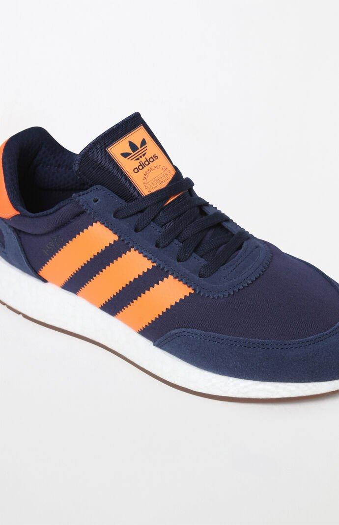 navy blue and orange adidas shoes