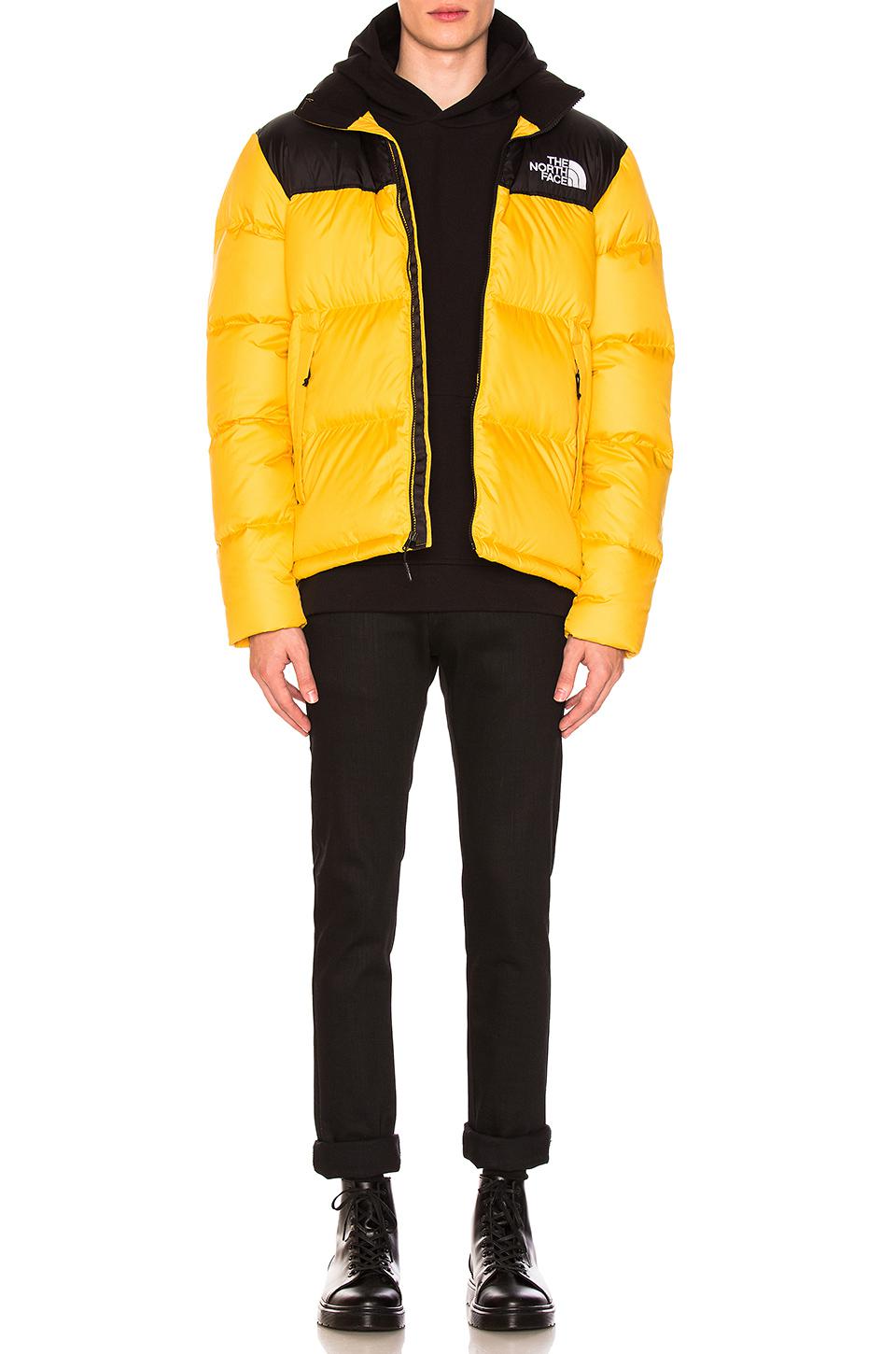 black and yellow north face puffer