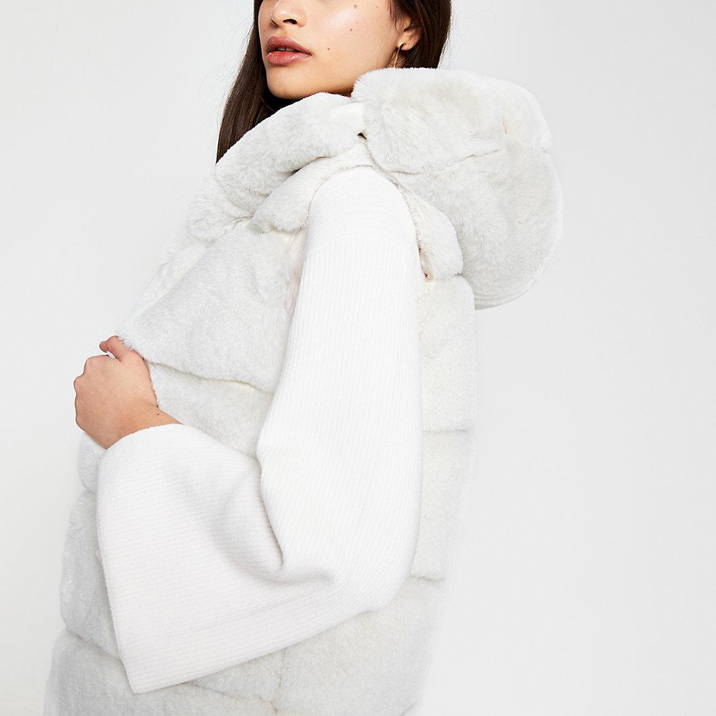 white gilet with fur hood