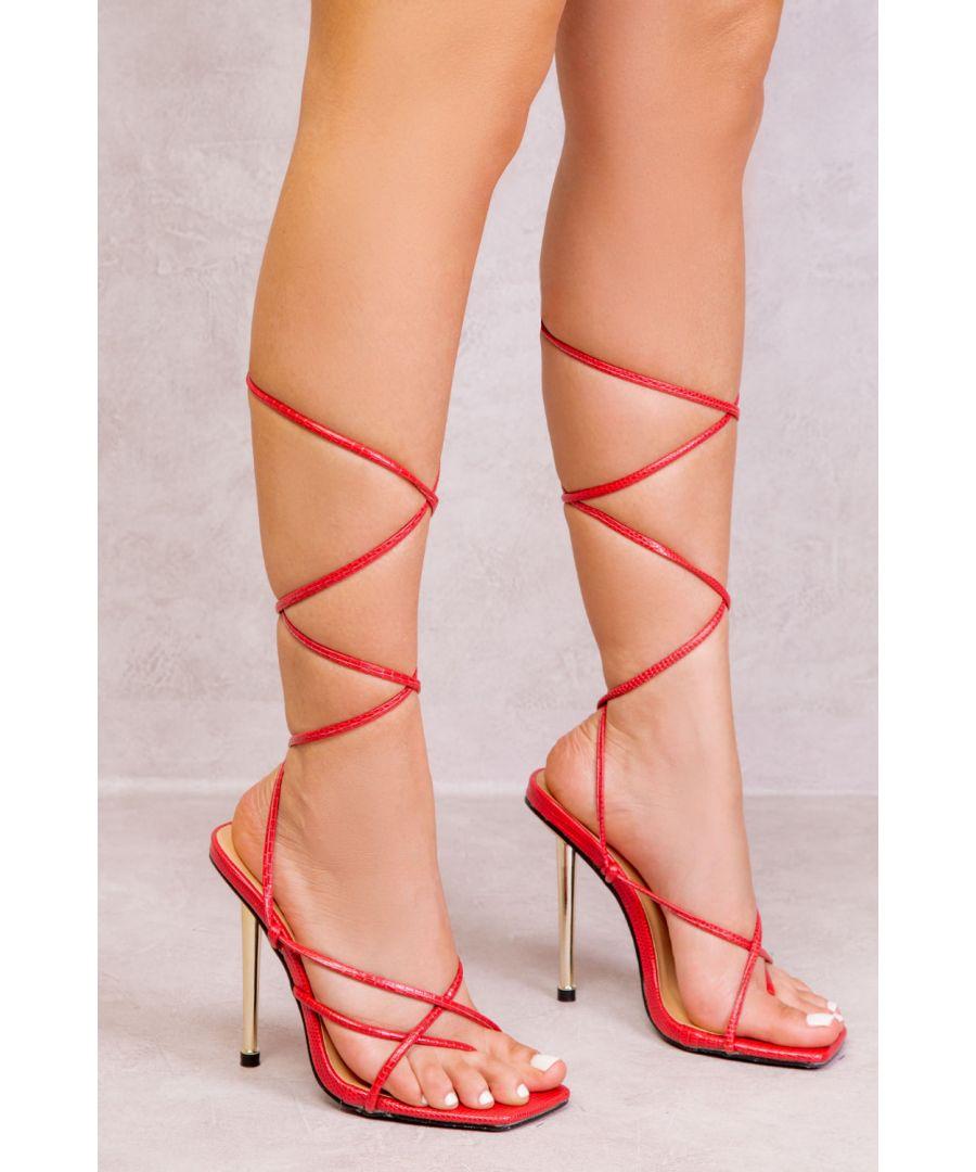 Woman in high heels. Woman s legs and feet wearing sexy red high heel shoes  that
