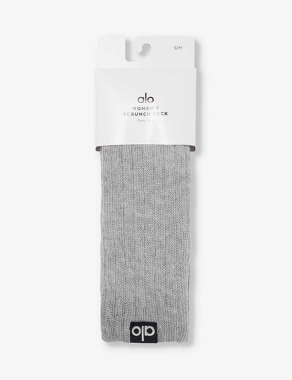 https://cdna.lystit.com/photos/selfridges/dc80a712/alo-yoga-Athletic-Heather-Grey-Logo-patch-Crew-length-Cotton-blend-Socks.jpeg