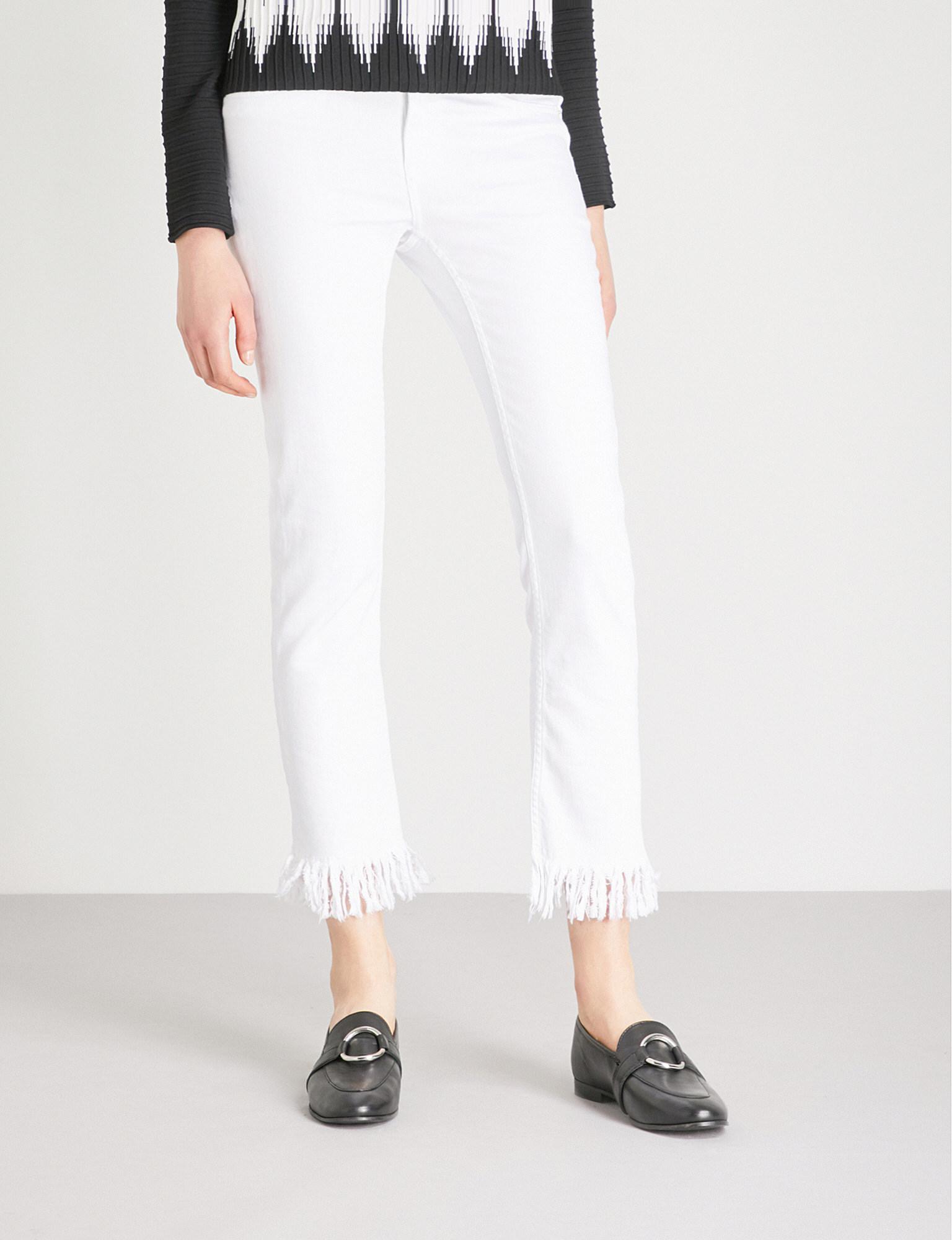 white jeans with frayed hem