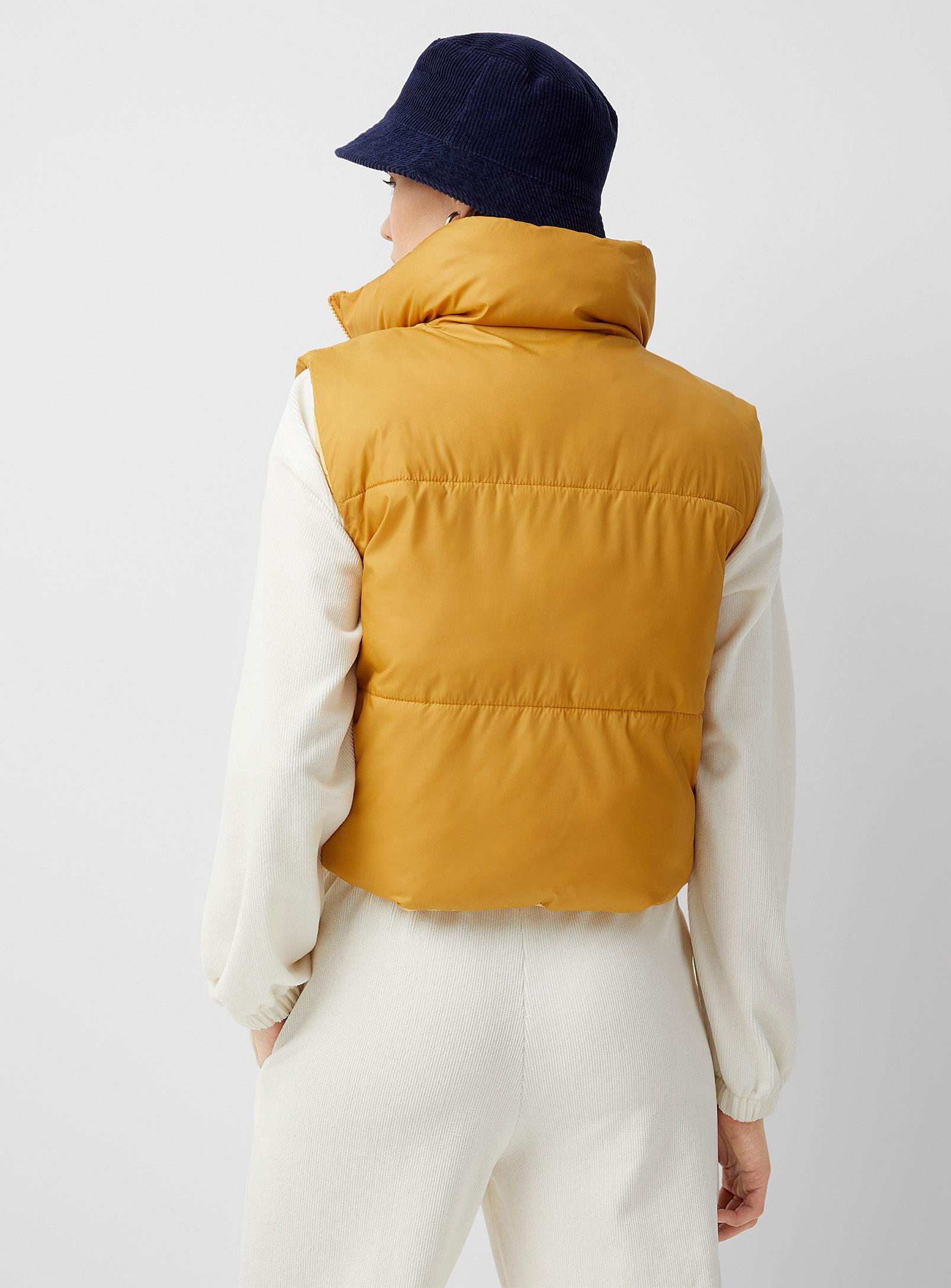 orange sleeveless puffer jacket