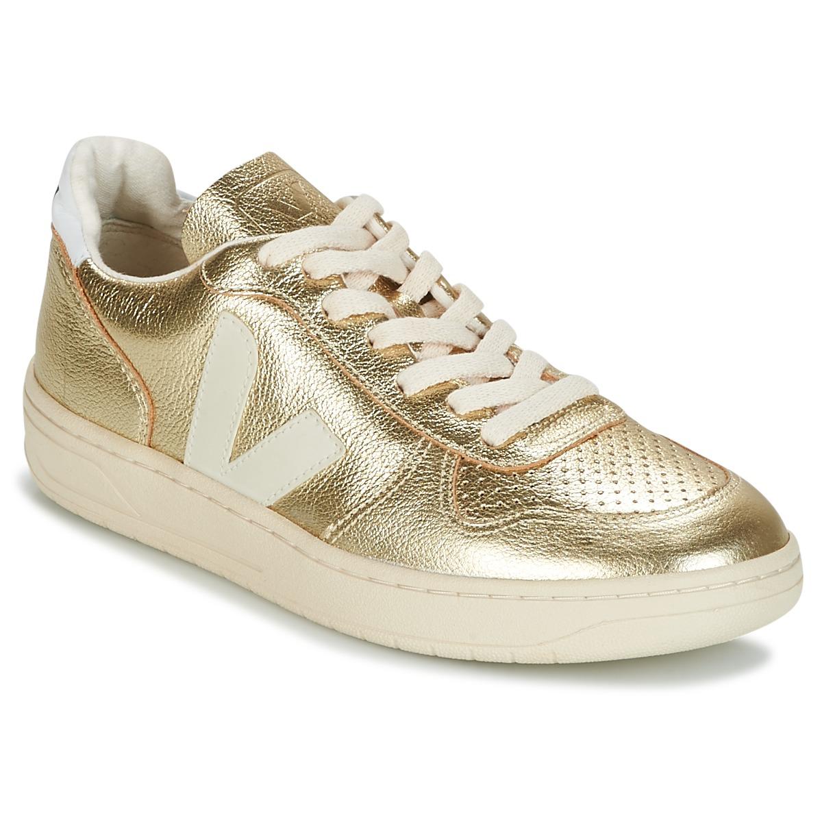 gold and gold trainers