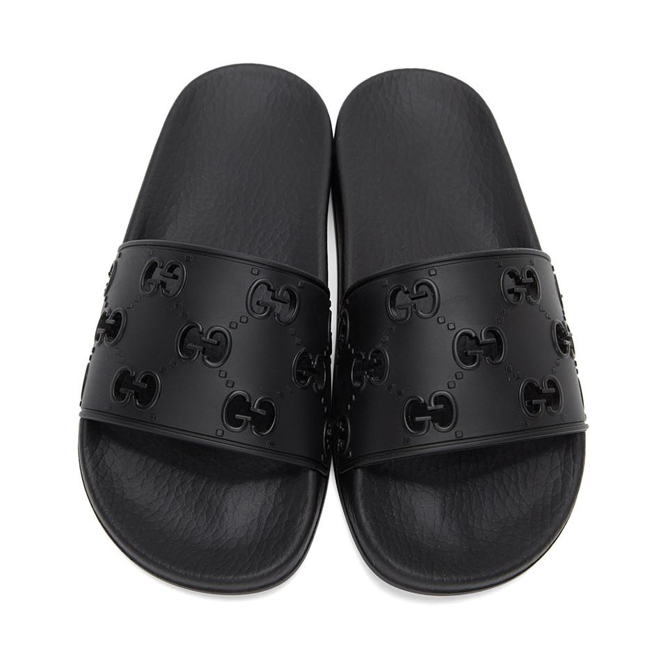 black gucci slides with gold g