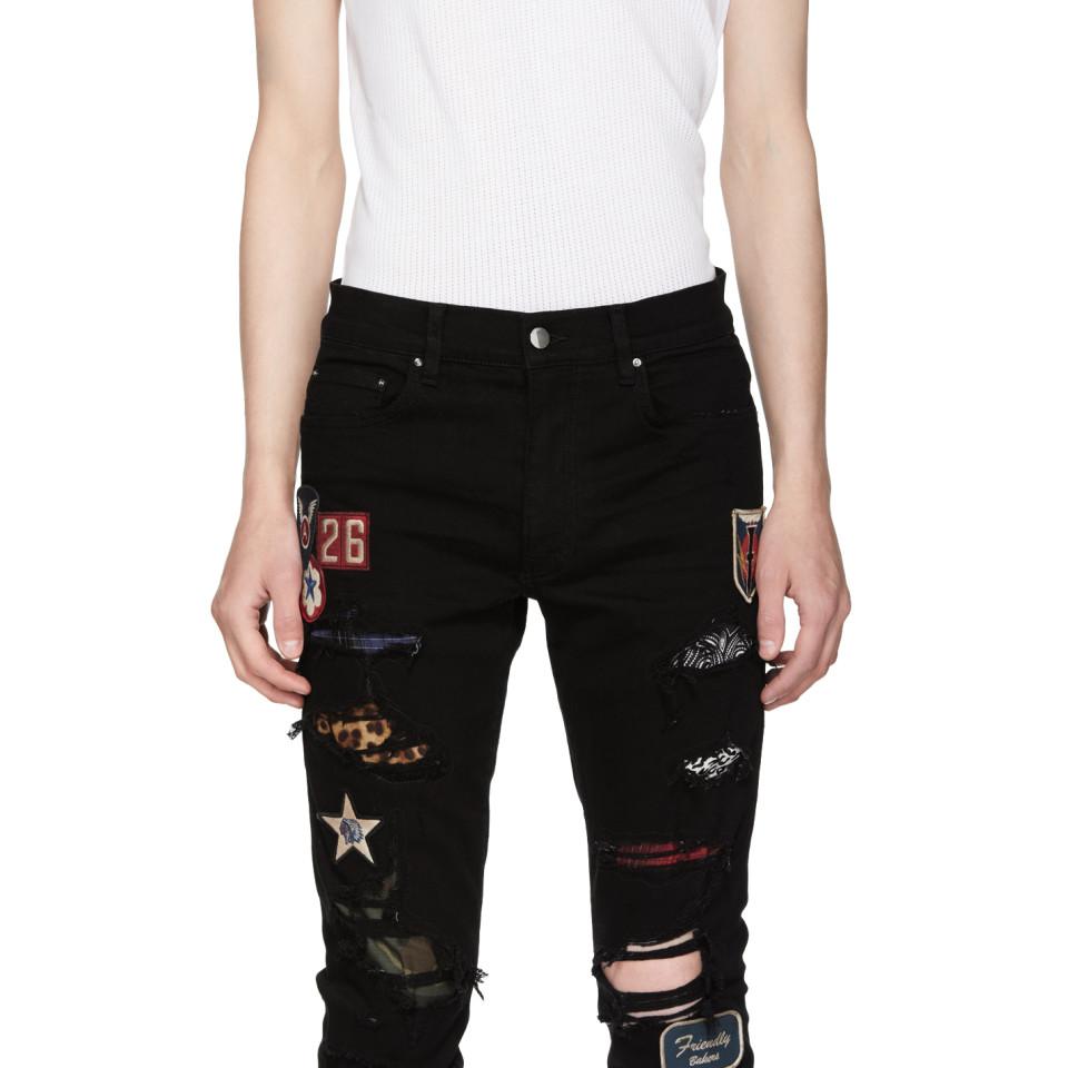 black amiri jeans with patches