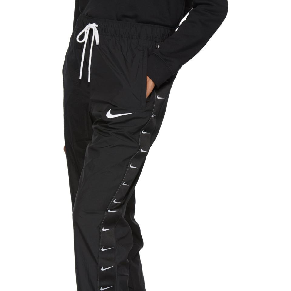 Nike Synthetic Black Woven Swoosh Lounge Pants | Lyst