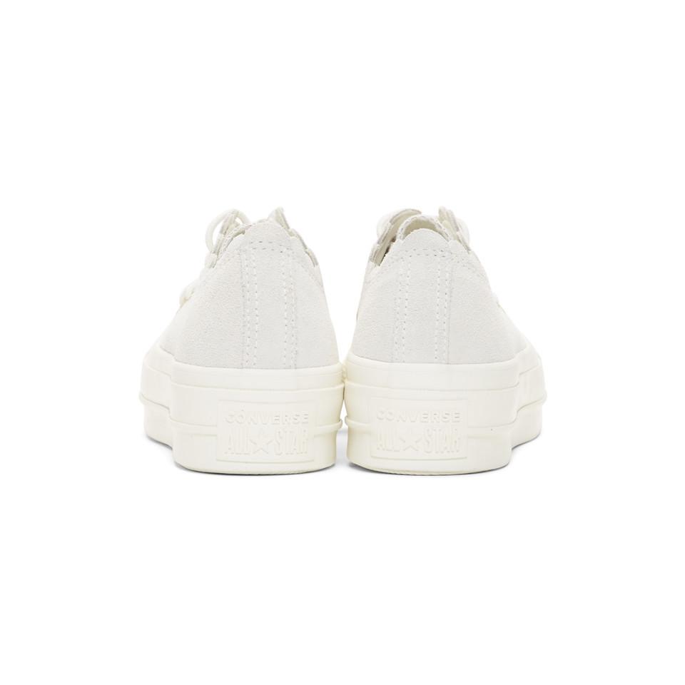 white frilly converse