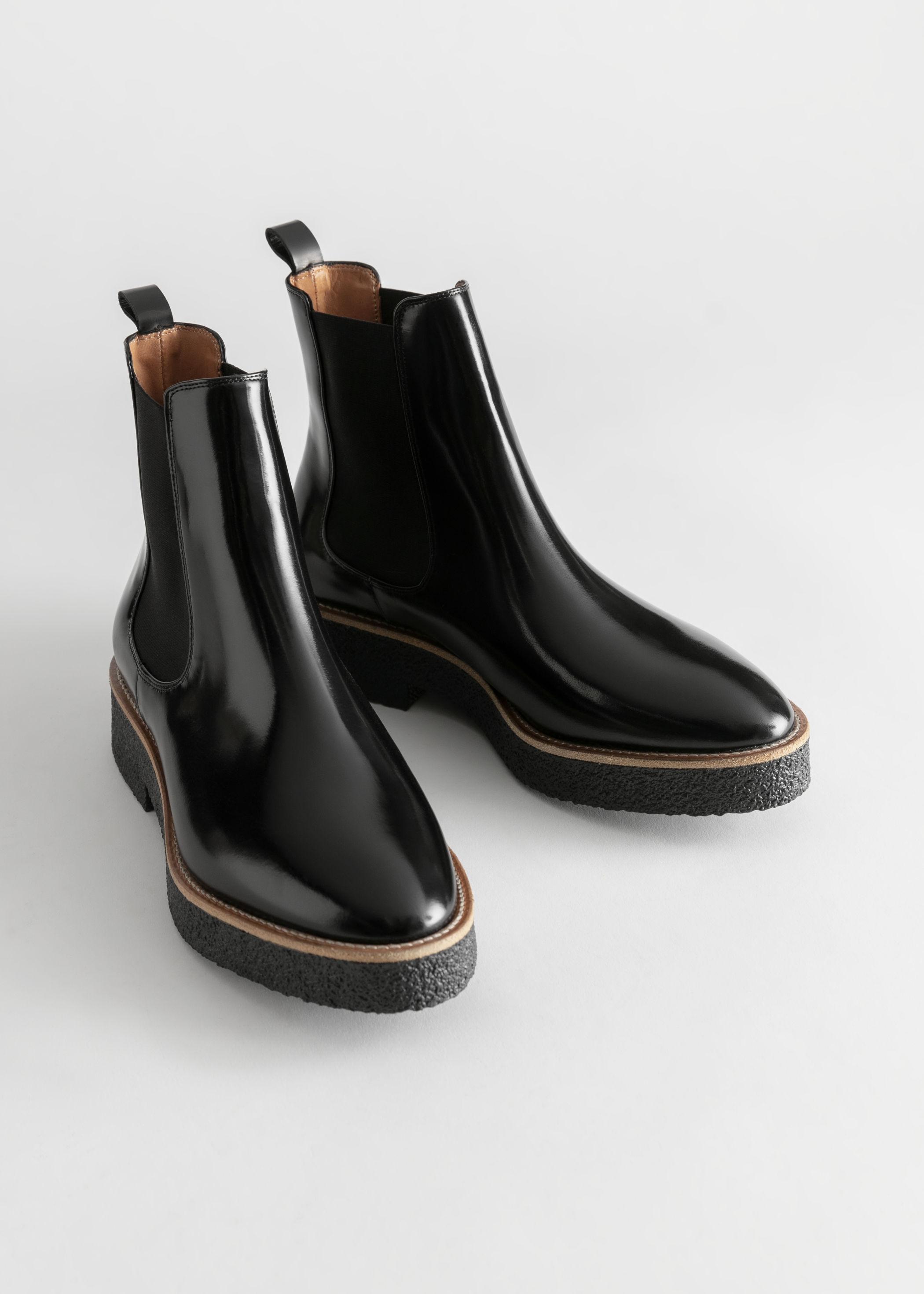 black sole stitch chelsea boots