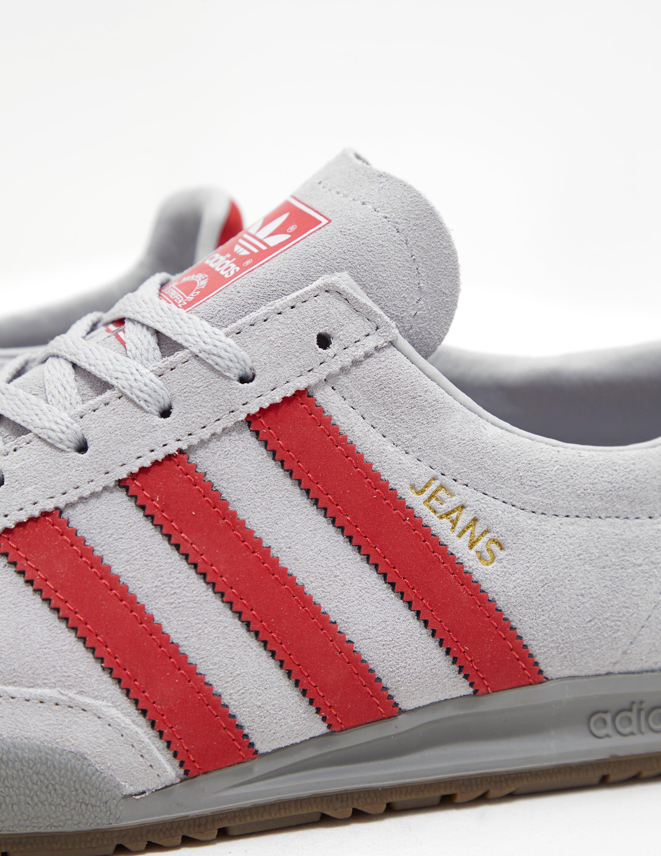 grey and red adidas jeans