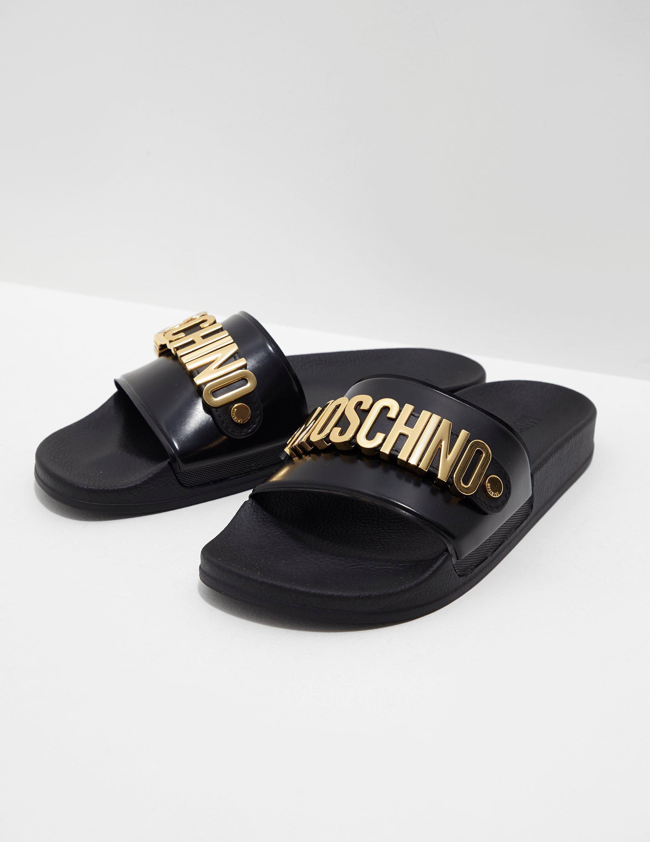 black and gold moschino slides