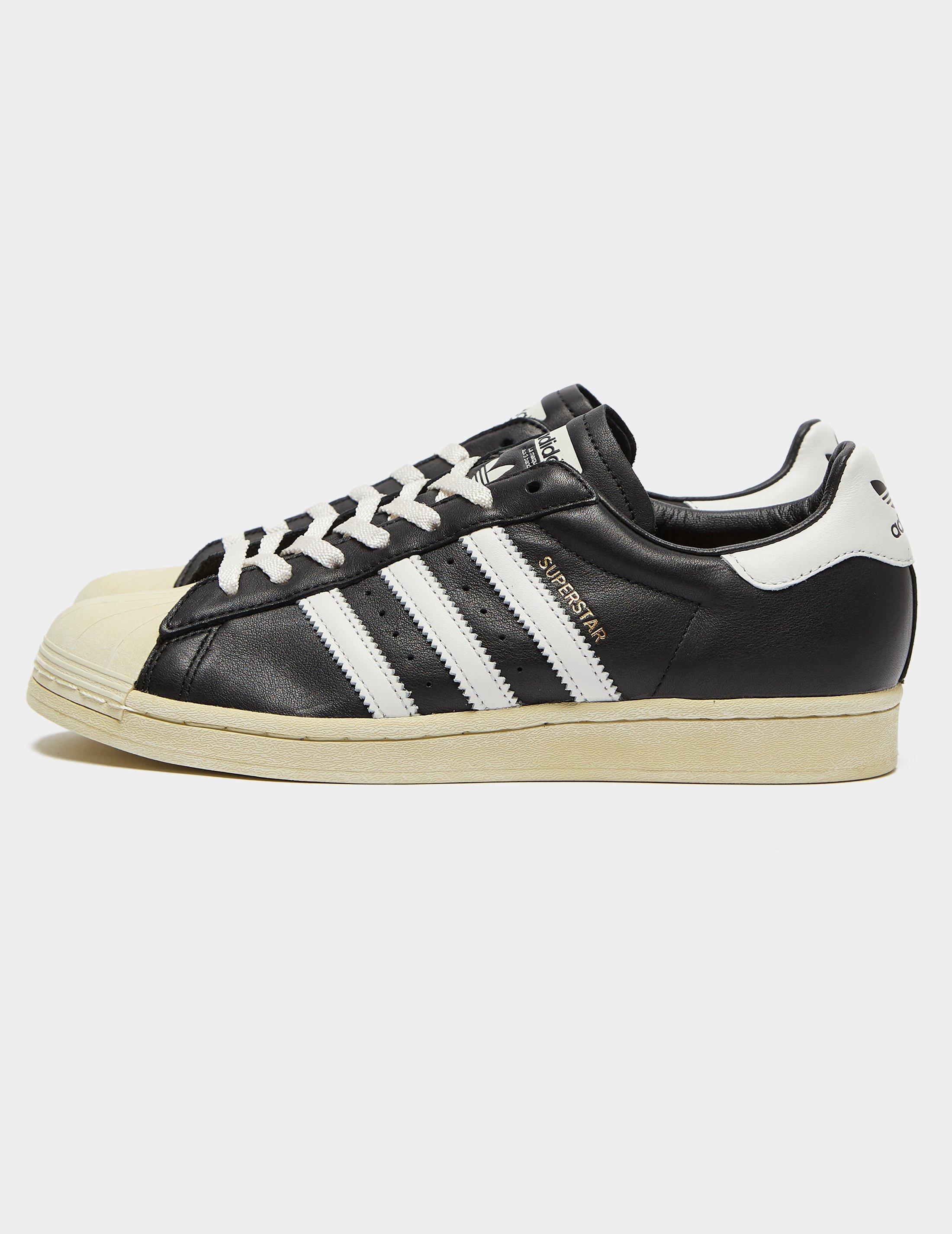 black and white superstar trainers