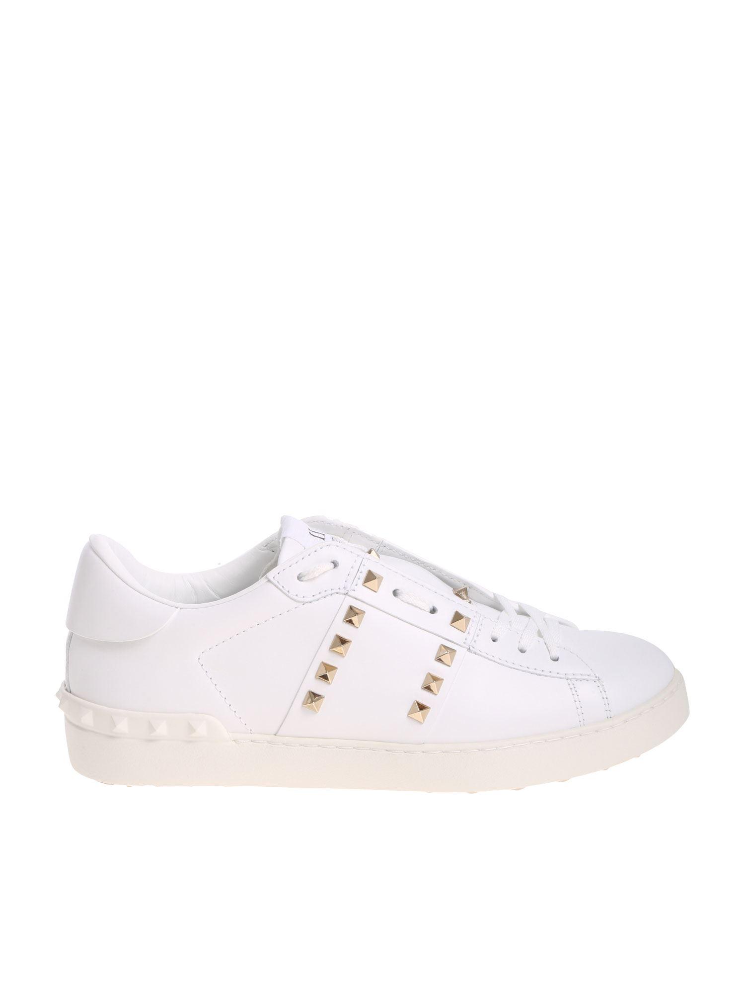 white sneakers with gold studs