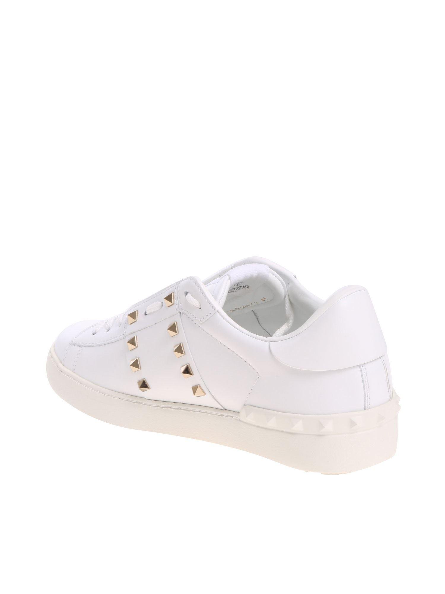 white sneakers with gold studs