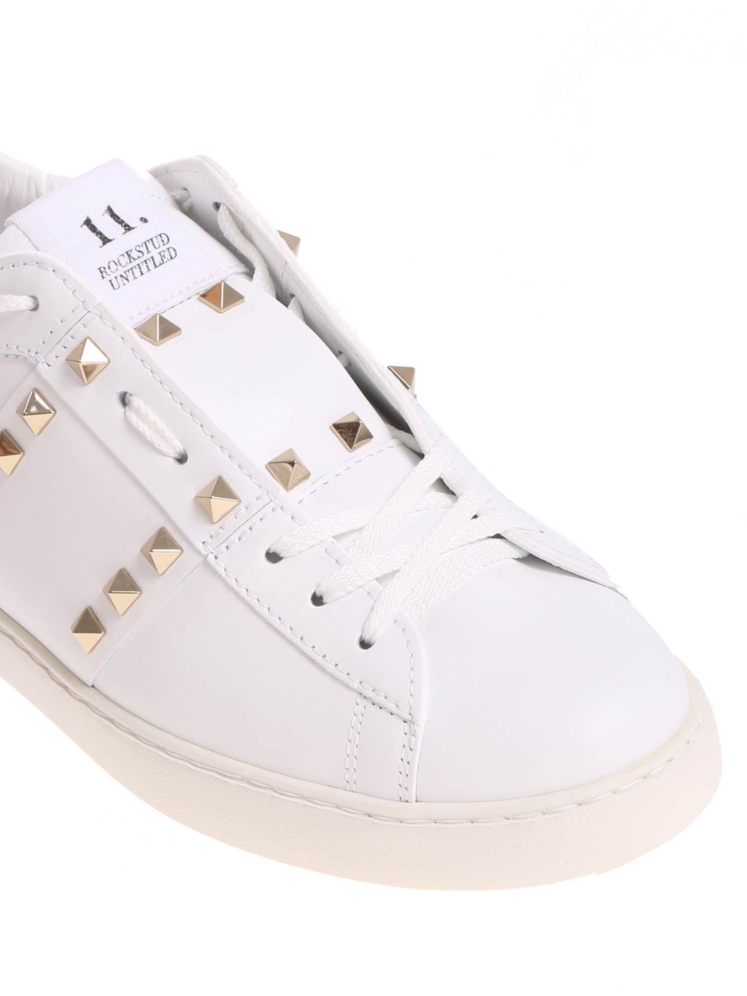 white sneakers with gold studs