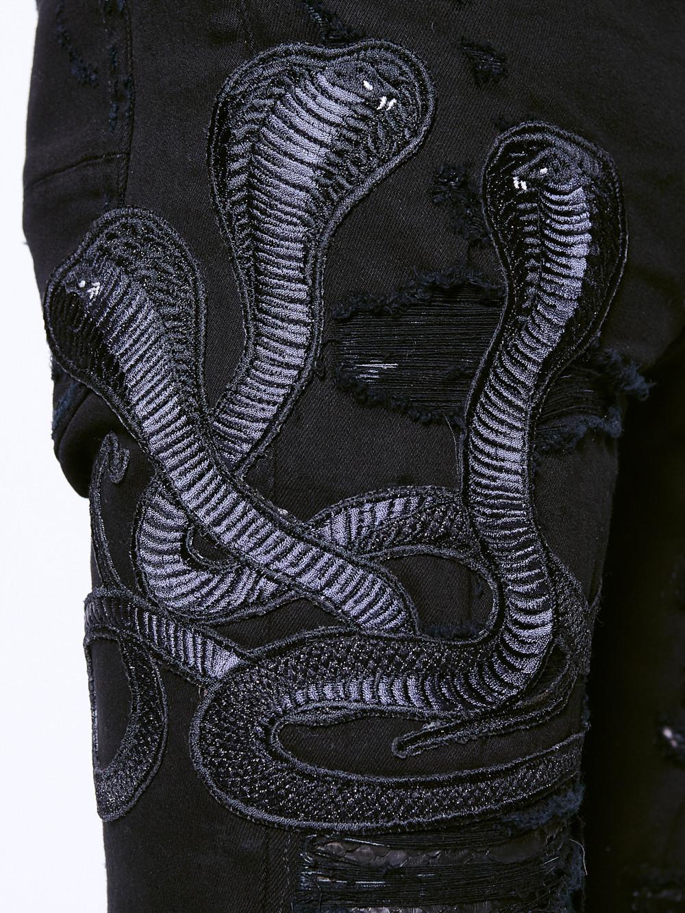 black amiri jeans with snake
