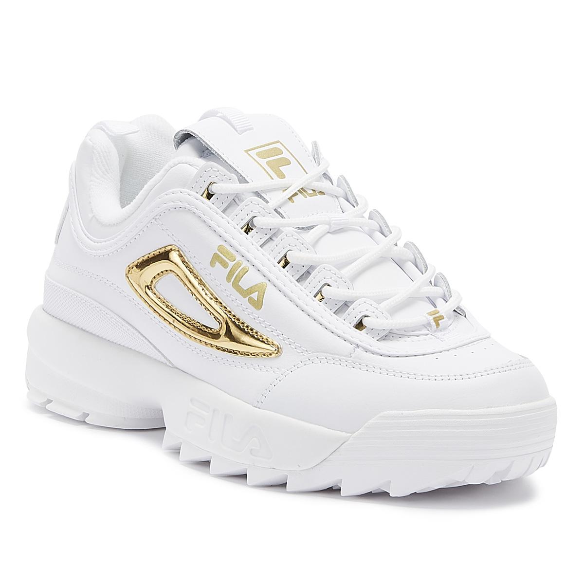 white and gold fila trainers