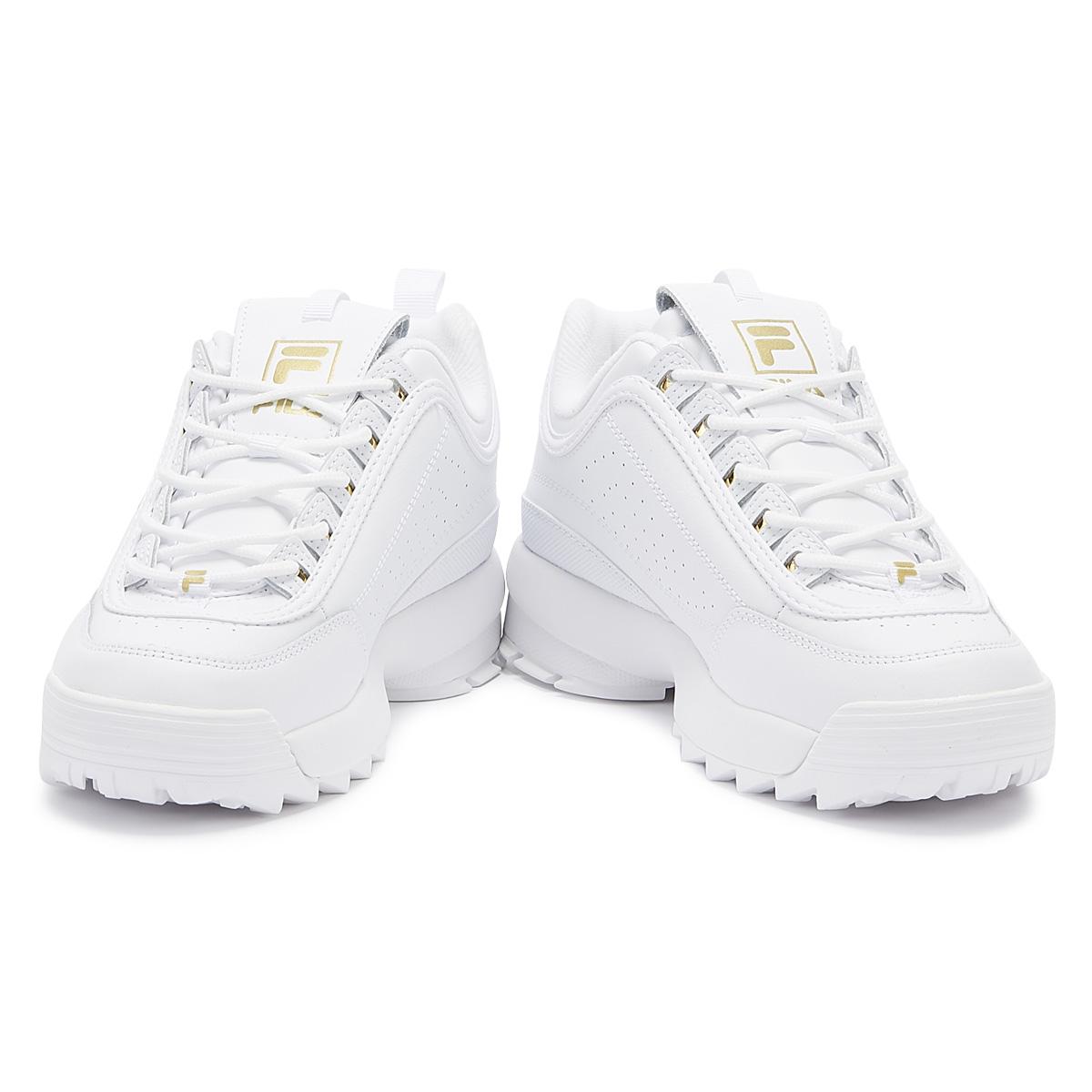 white and gold fila trainers