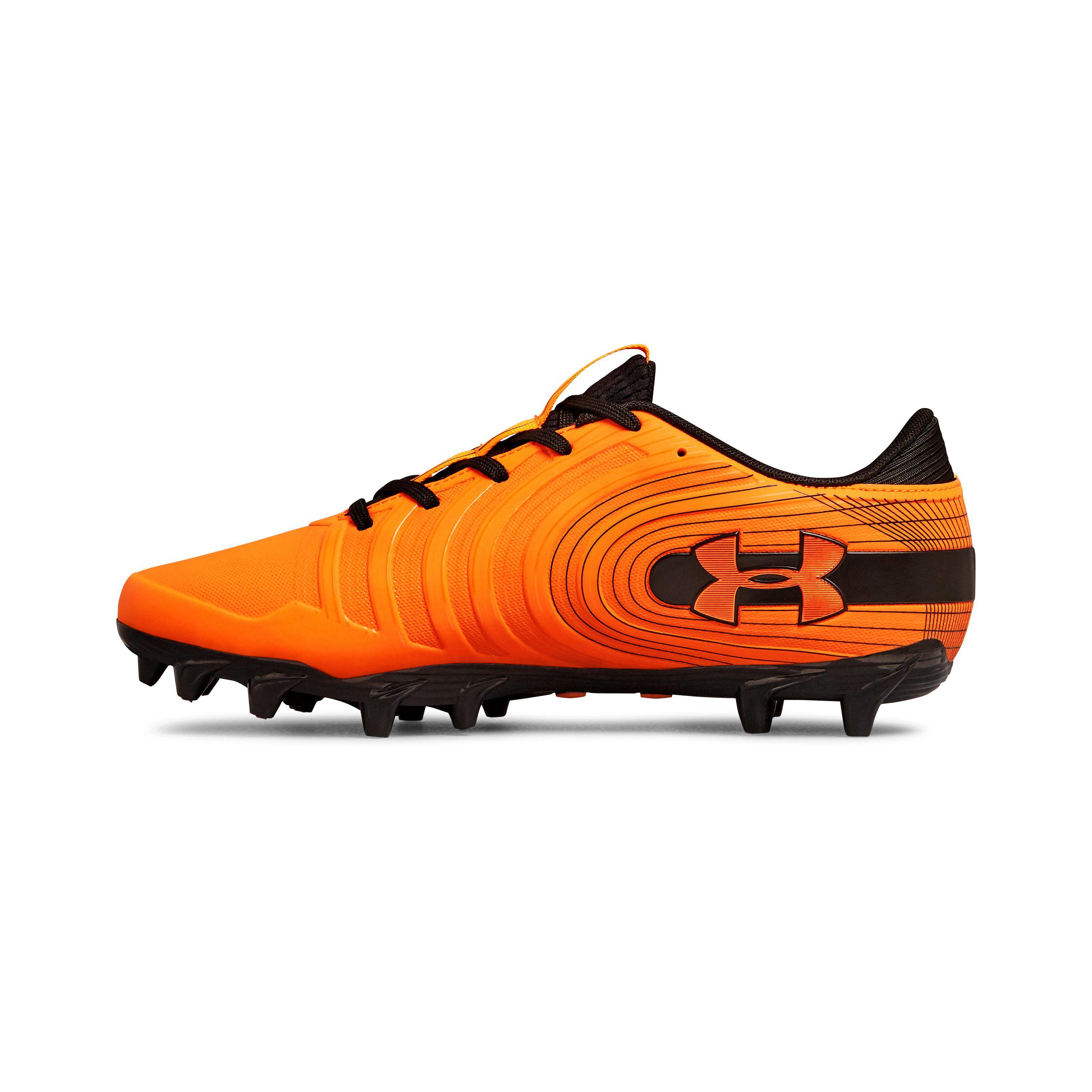orange and white under armour football cleats