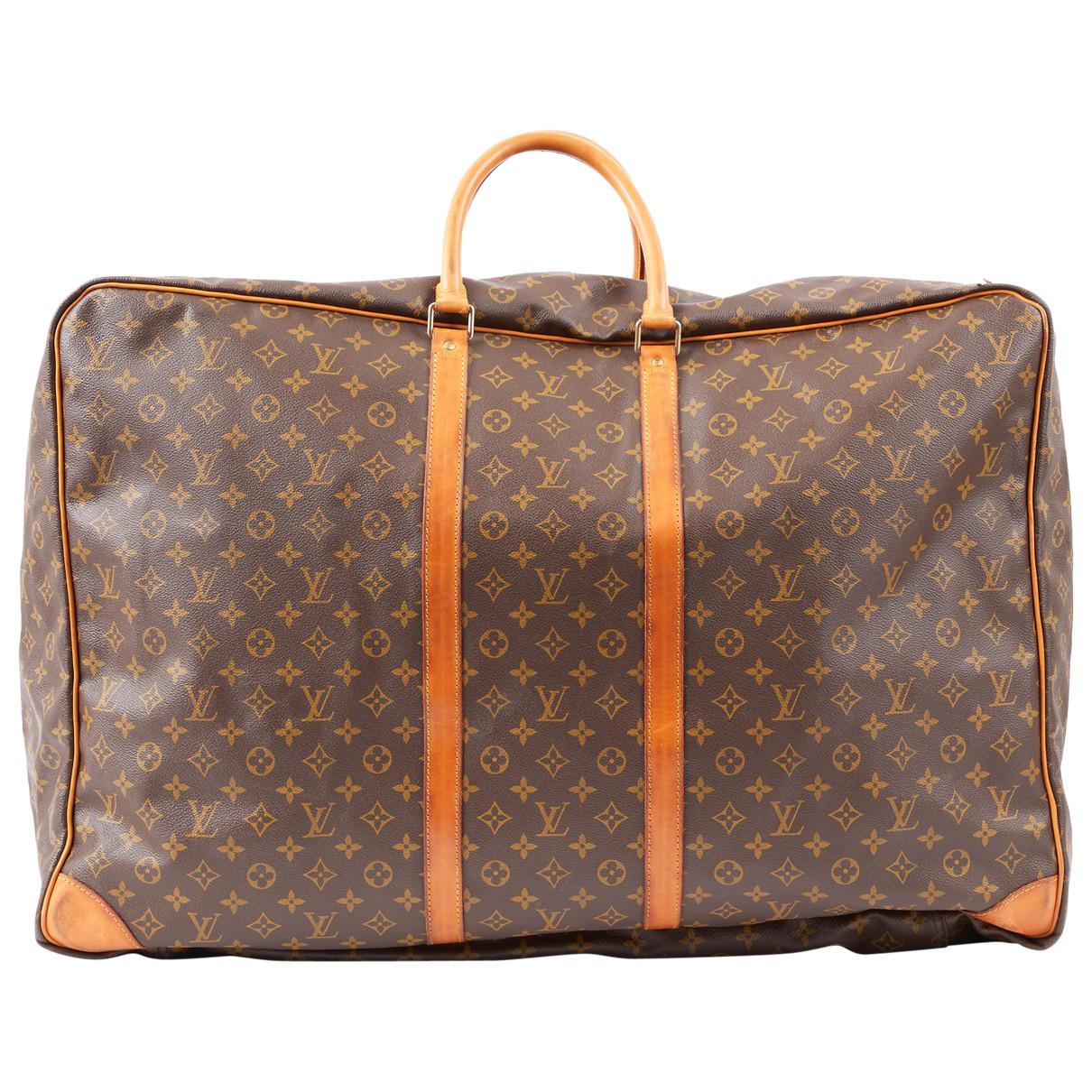 Louis Vuitton Leather Travel Bag in Brown - Lyst