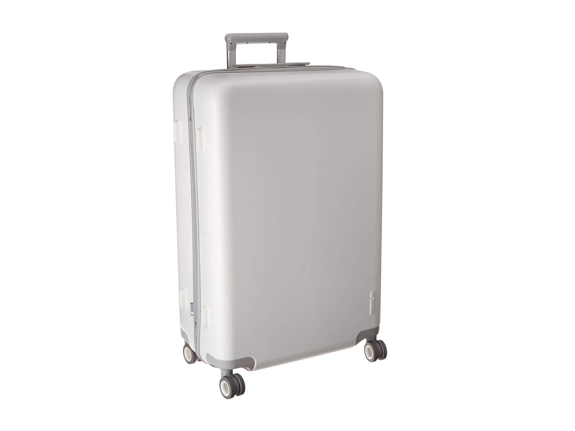 white hard shell luggage