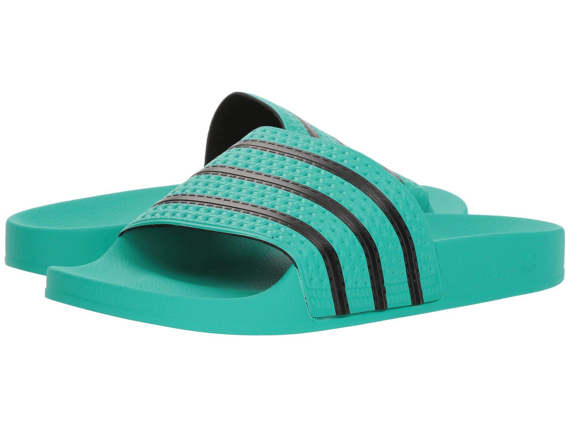 green and black adidas slides