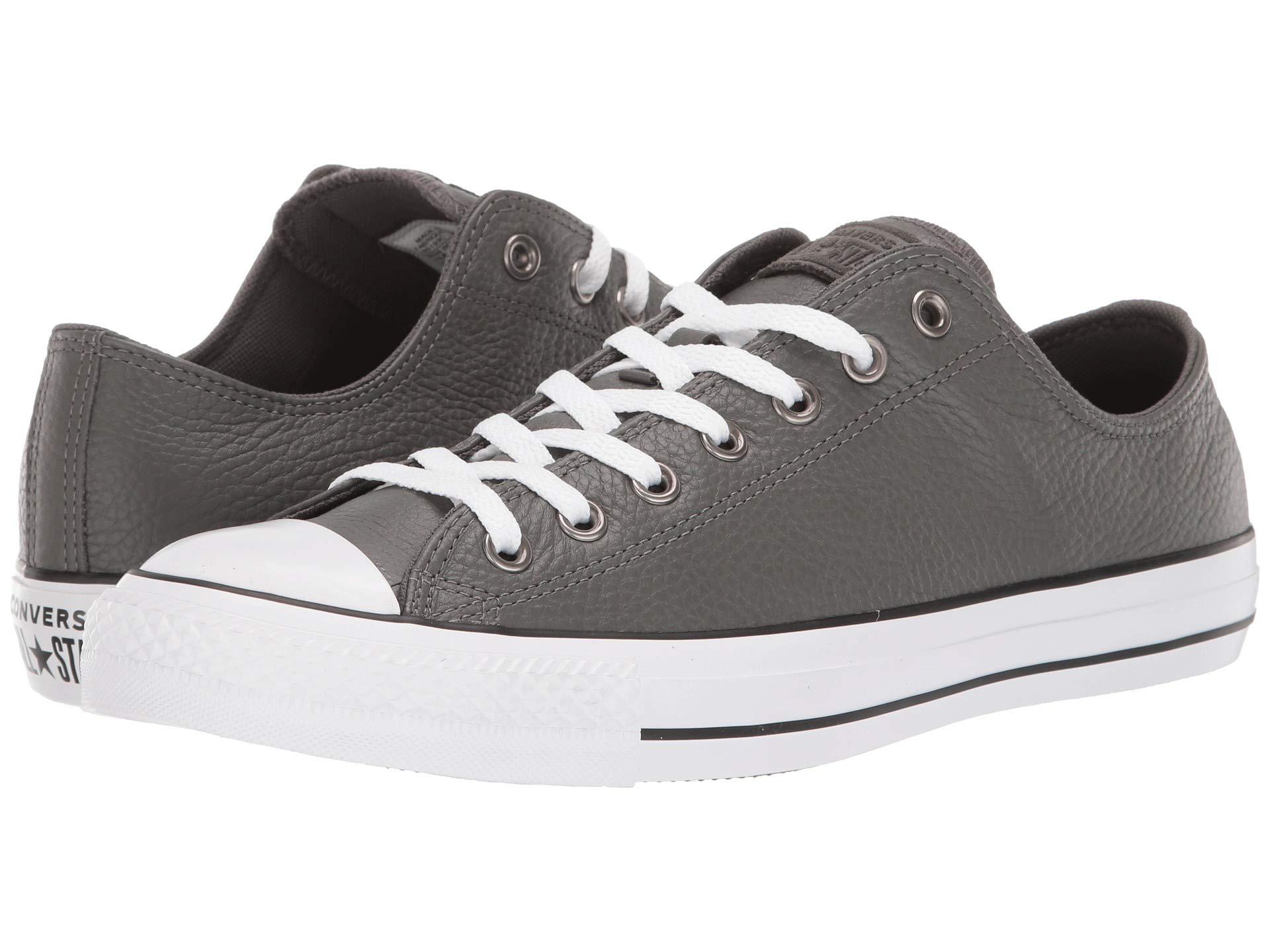 white and grey leather converse